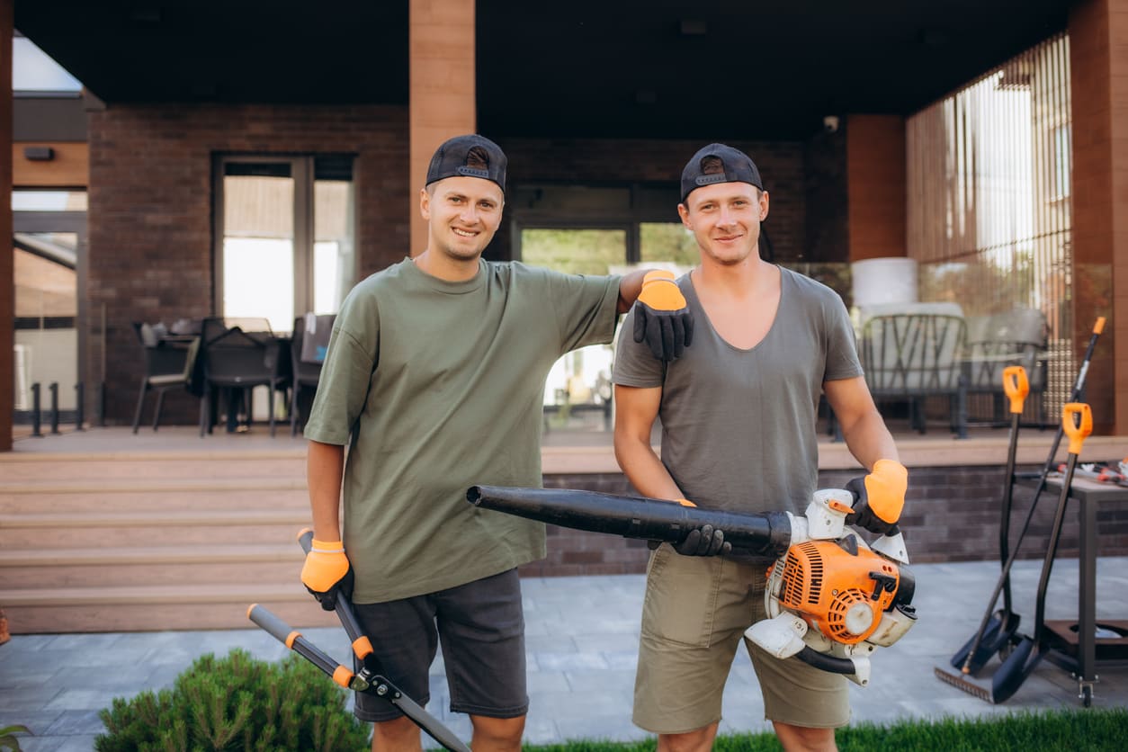 Rics Mowing team members with lawn care equipment