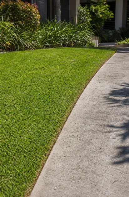 Clean lawn edging beside a concrete path